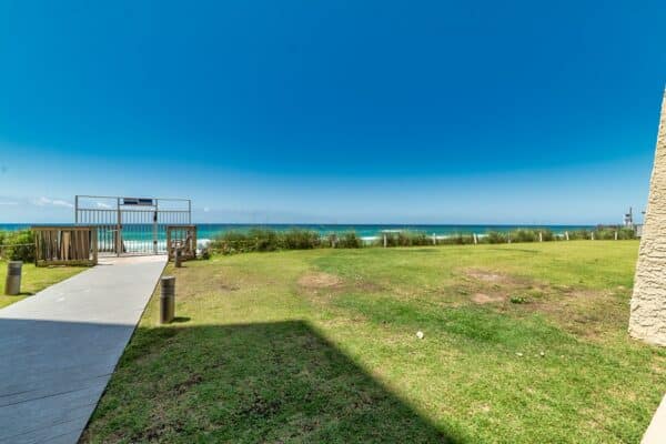 Coastal view at Beach House Condominiums, featuring a B105 path leading to an ocean-view pavilion.