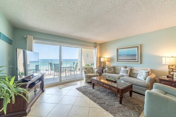 Bright beachfront living room at The Beach House Condominiums with a B201 ocean view balcony.