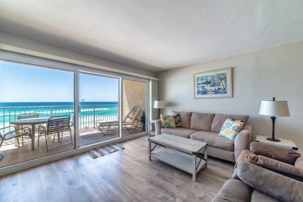 Beachfront living room in unit B402 at The Beach House Condominiums with ocean view balcony.