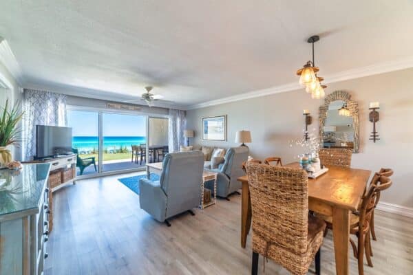 Coastal-themed living area with dining space d102 overlooking the ocean at The Beach House Condos.