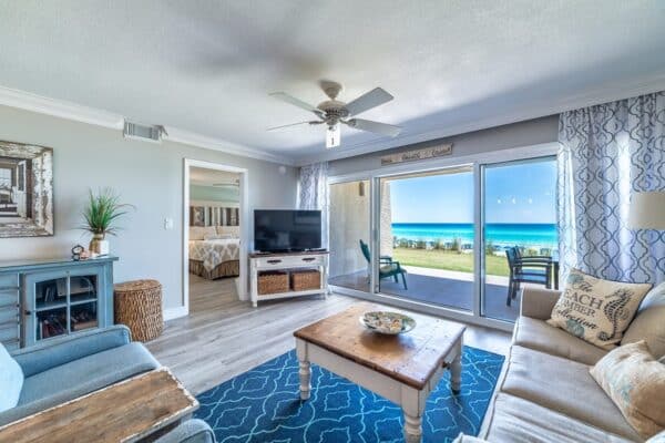 room in a Beach House Condo unit, with wide windows and modern furnishing.