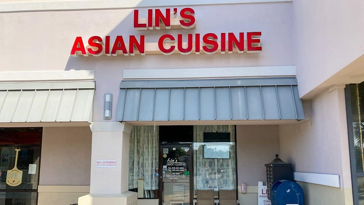 Exterior view of Lin's Asian Cuisine restaurant with 'Open' sign at Beach House Condominiums.