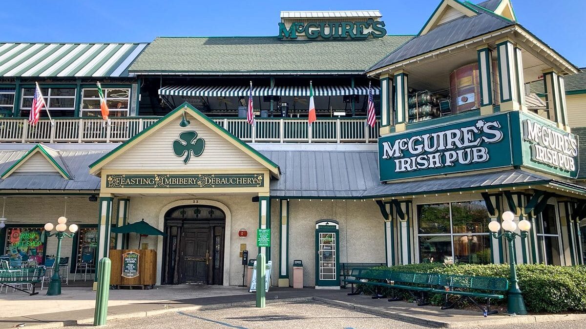 Exterior view of a pub with American and Irish flags, near The Beach House Condominiums.
