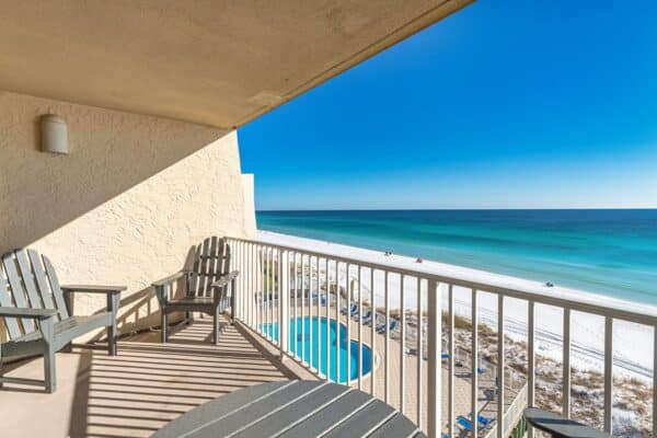 Balcony view at The Beach House Condominiums showing a beach and clear skies.