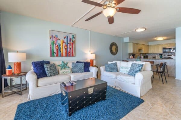 Modern, beach-themed living room leading to an open-plan in C602 at the Condominium Complex.